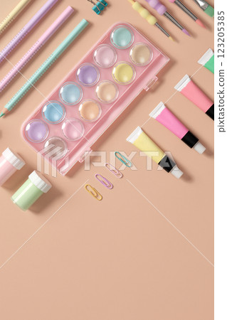 Banner with drawing supplies in green, yellow, pink and purple pastel colors on beige background. Space for your text. 123205385