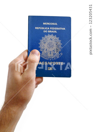 Man holding an Brazilian passport against a white background 123205431