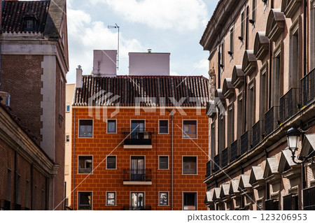 A classic view of Madrid's architecture featuring brick buildings with balconies and tiled roofs. A classic view of Madrid's architecture featuring brick buildings with balconies and tiled roofs. 123206953