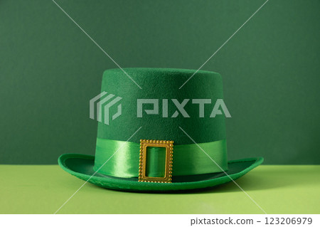 St Patricks day and March 17 concept with green parade Leprechaun Hat with belt and buckle on green background. Close up. St Patricks day and March 17 concept with green parade Leprechaun Hat with belt and buckle on green background. Close up. 123206979