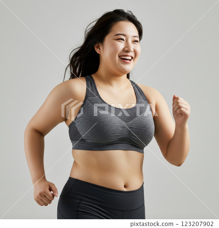 Chubby young woman running in sportswear (AI-generated image) 123207902