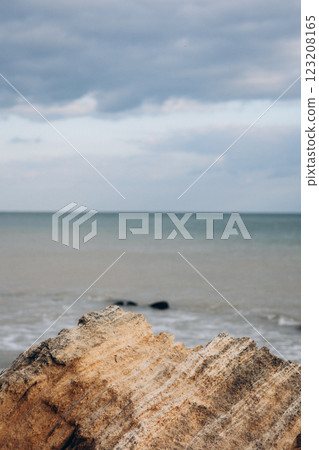 Early morning sunrise over the sea . Some clouds. 123208165