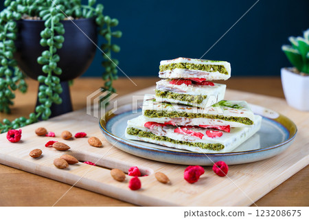 Piece of trend Dubai white chocolate with pistachio paste and kataifi dough, Confectionery handmade sweets at home in the kitchen. High quality photo 123208675