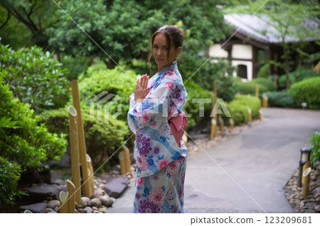 Elegant Woman in Kimono Practicing Mindfulness in Garden Elegant Woman in Kimono Practicing Mindfulness in Garden 123209681