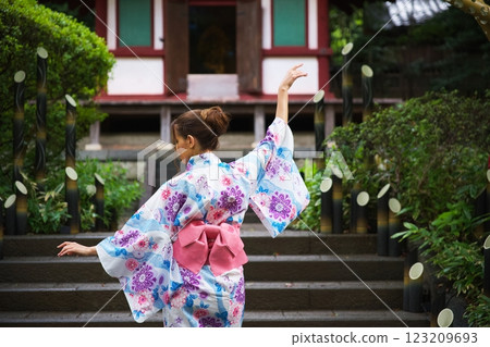 Graceful Woman in Kimono Dancing Near Japanese Temple Graceful Woman in Kimono Dancing Near Japanese Temple 123209693