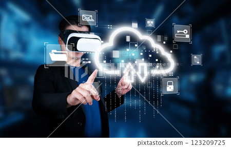 Person in Virtual Reality Headset Interacting with Cloud Computing Interface and Data Symbols in Modern Digital Environment XDMCP 123209725