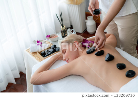 Hot stone massage at spa salon in luxury resort. Quiescent 123209730