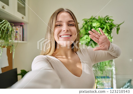 Close-up selfie portrait of young cheerful woman looking at web camera Close-up selfie portrait of young cheerful woman looking at web camera 123210543