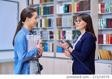Meeting dialogue, teenage girl student talking with female teacher Meeting dialogue, teenage girl student talking with female teacher 123210579