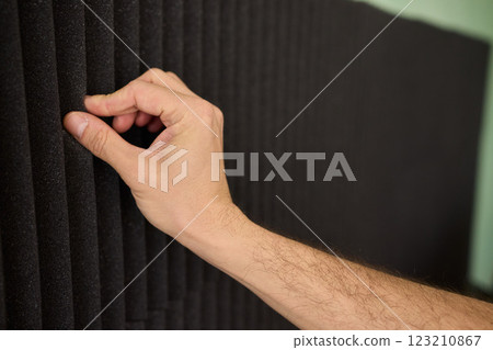 Applying Acoustic Panels for Effective Soundproofing and Enhanced Room Acoustics 123210867