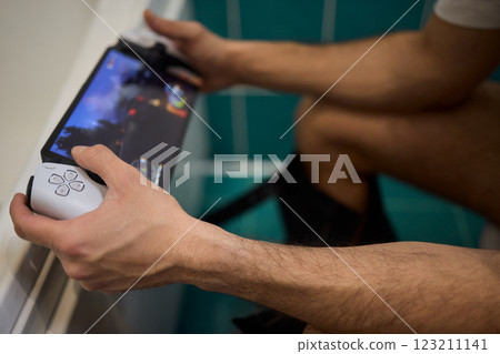 A Man Engaged in a Leisurely Activity While Relaxing in a Comfortable Bathroom Setting A Man Engaged in a Leisurely Activity While Relaxing in a Comfortable Bathroom Setting 123211141