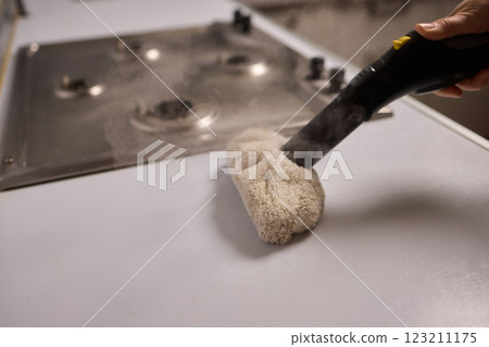 Achieving Efficient and Thorough Cleaning with a Steam Cleaner in a Modern Kitchen Setting 123211175