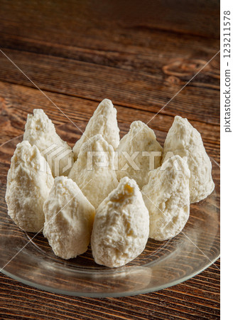 Large chocolates on a brown wooden background. 123211578