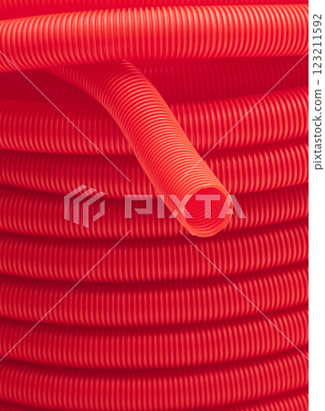 Plastic corrugated hose close-up. Red background. Plastic corrugated hose close-up. Red background. 123211592