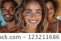 a group of people are smiling for the camera while standing next to each other 123211686