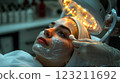 A woman is enjoying a facial treatment at a beauty salon 123211692