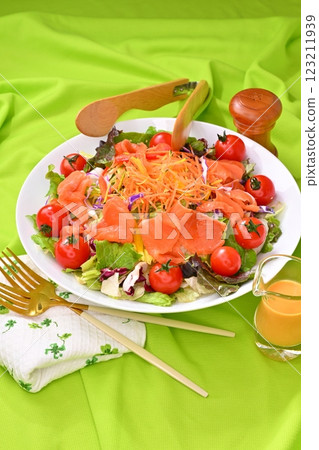 A heaping serving of vegetable salad with lettuce, cabbage, carrots, and cherry tomatoes, served with carrot dressing. A heaping serving of vegetable salad with lettuce, cabbage, carrots, and cherry tomatoes, served with carrot dressing. 123211939