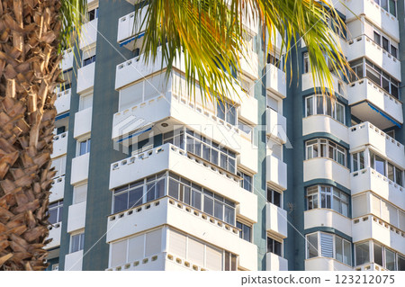 Malaga, seaside city in Andalusia, Spain, Europe. Modern apartment building with balconies and palm trees. Malaga, seaside city in Andalusia, Spain, Europe. Modern apartment building with balconies and palm trees. 123212075
