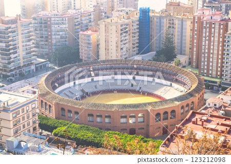 Malaga, seaside city in Andalusia, Spain, Europe. Aerial view of a bullring nestled amongst city buildings. A unique blend of architecture and urban landscape. 123212098