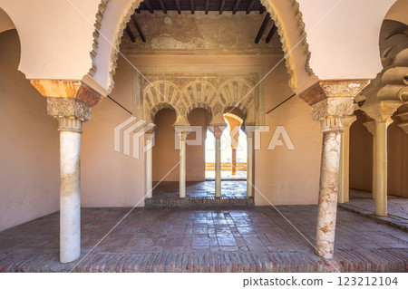 Alcazaba, palace and fortification in Malaga city at Andalusia, Spain, Europe. Ornate arches and columns in a historic building. Intricate details and warm light create a serene atmosphere. 123212104