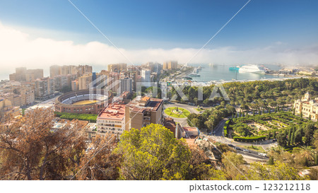 Malaga, seaside city in Andalusia, Spain, Europe. Coastal city panorama with harbor, bullring, and lush parklands under a sunny sky. 123212118