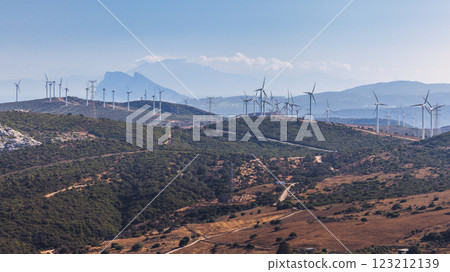 Wind turbines on a hillside, clean energy against a mountain backdrop. The Rock of Gibraltar on background. 123212139