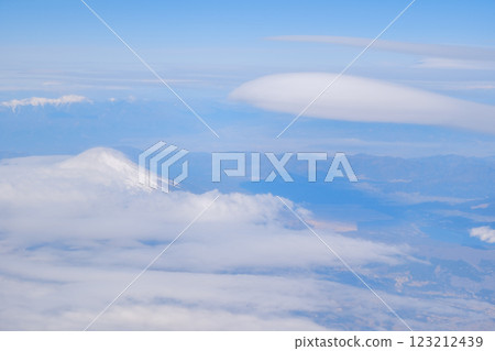 A view of the hanging clouds of Mt. Fuji from an airplane A view of the hanging clouds of Mt. Fuji from an airplane 123212439