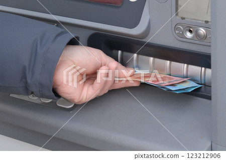 Hand of man to withdraw money from an ATM Hand of man to withdraw money from an ATM 123212906