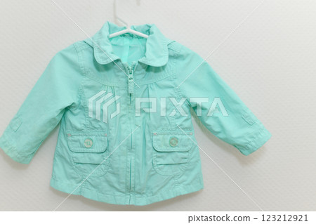 Menthol colored jacket hanging on hanger on white background 123212921