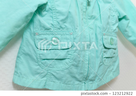 Menthol colored jacket hanging on hanger on white background 123212922
