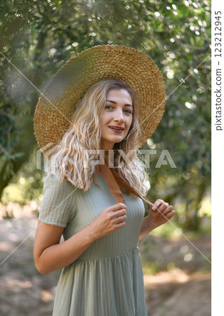 Blonde woman in a straw hat in the olive gardens of Provence Blonde woman in a straw hat in the olive gardens of Provence 123212945