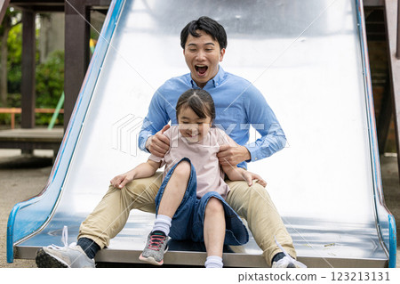 Parent and child playing in the park Parent and child playing in the park 123213131