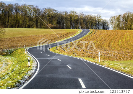 Empty black asphalt road between green fields Empty black asphalt road between green fields 123213757