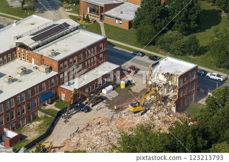Demolition of Historic Edwards Building in Berea, Kentucky. Crawler excavator demolishing brick walls of old structure 123213793
