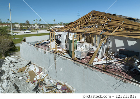 Damaged house roof and walls after hurricane Ian in Florida. Consequences of natural disaster Damaged house roof and walls after hurricane Ian in Florida. Consequences of natural disaster 123213812