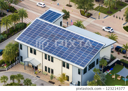 Autonomous building in Florida with photovoltaic rooftop covered with solar panels for producing of clean ecological electrical energy in town center 123214377