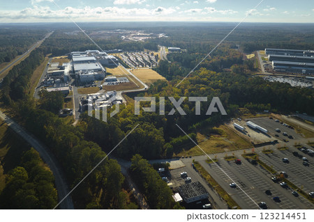 Aerial view of many employee cars parked on parking lot in front of industrial factory building Aerial view of many employee cars parked on parking lot in front of industrial factory building 123214451