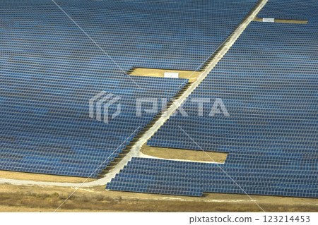 Aerial view of large sustainable electrical power plant with rows of solar photovoltaic panels for producing clean electric energy. Concept of renewable electricity with zero emission Aerial view of large sustainable electrical power plant with rows of solar photovoltaic panels for producing clean electric energy. Concept of renewable electricity with zero emission 123214453