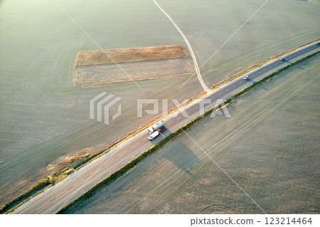 Aerial view of intercity road with fast driving cars at sunset. Top view from drone of highway traffic in evening 123214464