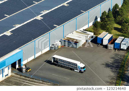 Aerial view of blue photovoltaic solar panels mounted on industrial building roof for producing green ecological electricity. Production of sustainable energy concept 123214640