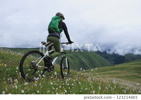 Riding mountain bike on grassland mountain top 123214865