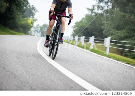 Woman cycling on summer park trail 123214869