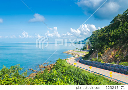 Scenic coastal road with blue sky and water at the Coastline of the Noen Nangphaya viewpoint, Chanthaburi, Thailand 123215471