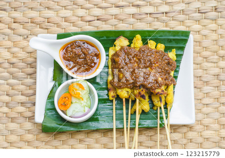 Satay with peanut sauce and cucumber salad, Bangkok, Thailand Satay with peanut sauce and cucumber salad, Bangkok, Thailand 123215779