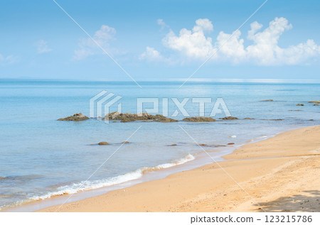 Serene beach with calm blue waters and clouds. Serene beach with calm blue waters and clouds. 123215786