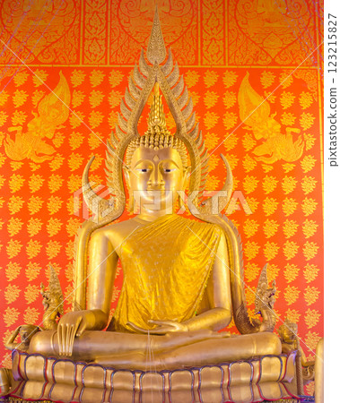 Golden Buddha statue against decorative background Golden Buddha statue against decorative background 123215827