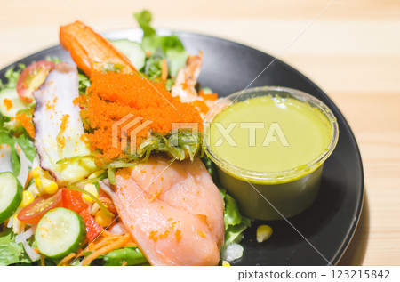Fresh seafood wasabi salad with colorful toppings and dressing. 123215842