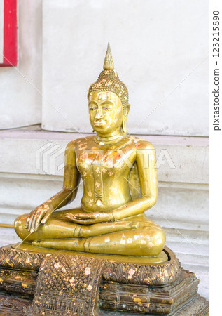 Golden Buddha statue in serene meditation pose Golden Buddha statue in serene meditation pose 123215890