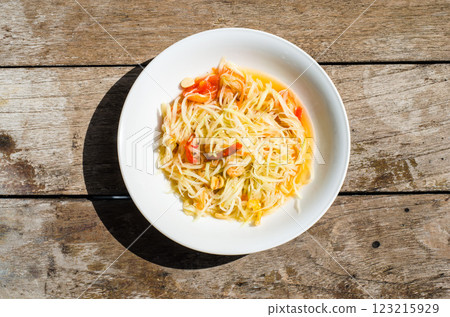 Thai Green Papaya Salad Som Tum dish on wooden table 123215929