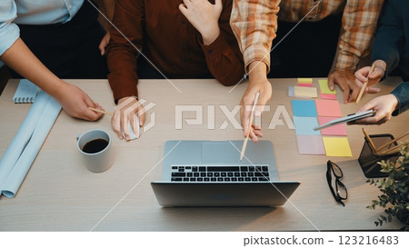 Collaborative Workspace with Diverse Hands Engaged in Creative Brainstorming over Laptop and Colorful Sticky Notes on Desk SACTR Collaborative Workspace with Diverse Hands Engaged in Creative Brainstorming over Laptop and Colorful Sticky Notes on Desk SACTR 123216483